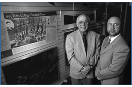 two guys standing in front of a display case